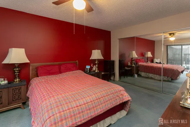 a bedroom with a bed and a lamp