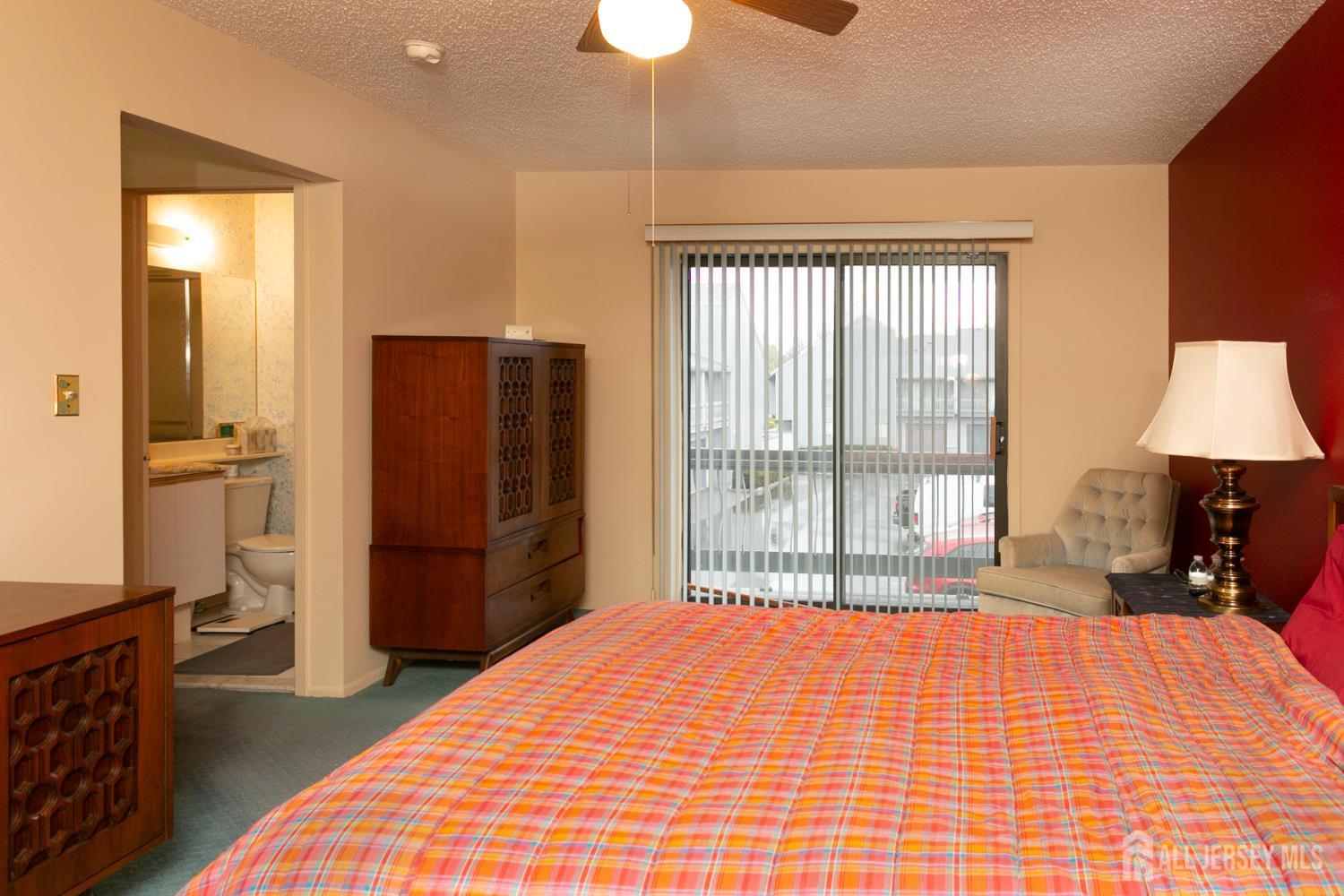 77 Linda Lane Edison, NJ 08820 - Photo 12 of 21 a bedroom with a bed and a lamp on dresser