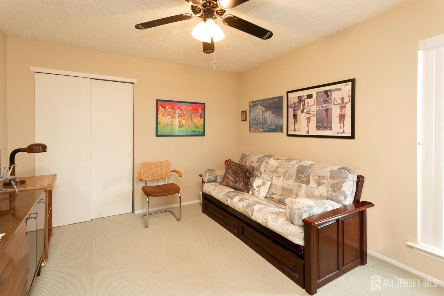 77 Linda Lane Edison, NJ 08820 - Photo 16 of 21 a living room with furniture and a ceiling fan