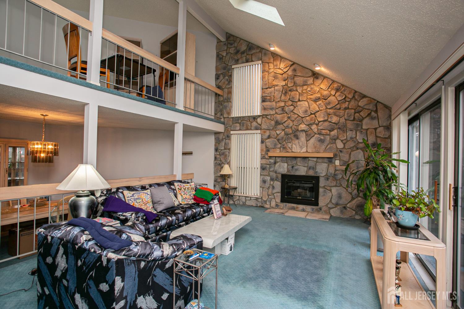 77 Linda Lane Edison, NJ 08820 - Photo 3 of 21 a living room with furniture a fireplace and a chandelier