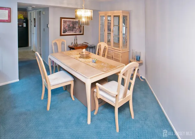 a view of a dining room with furniture and window
