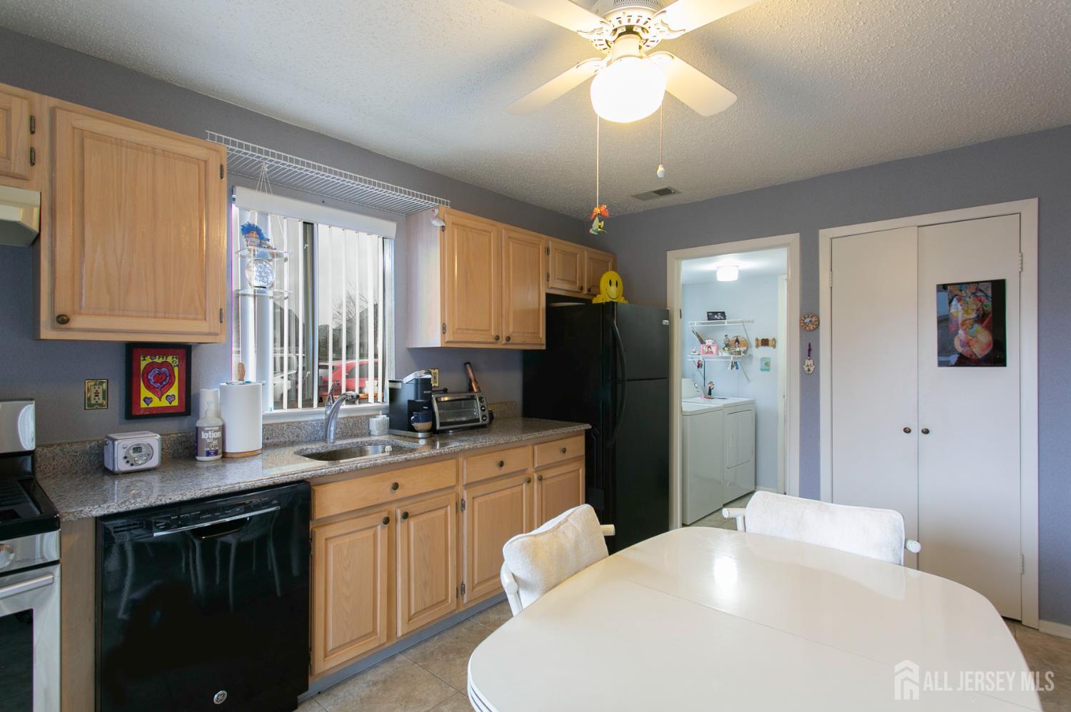 77 Linda Lane Edison, NJ 08820 - Photo 8 of 21 a kitchen with a refrigerator a sink a stove cabinets and a window