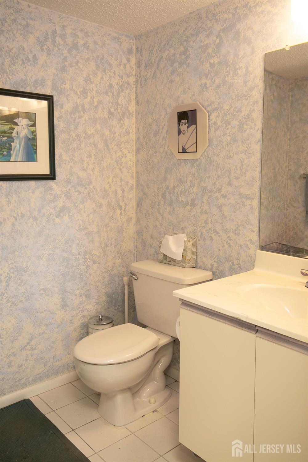 77 Linda Lane Edison, NJ 08820 - Photo 10 of 21 a white toilet sitting next to a bathroom sink