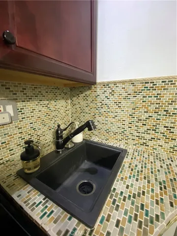 a room with water heater and wooden floor