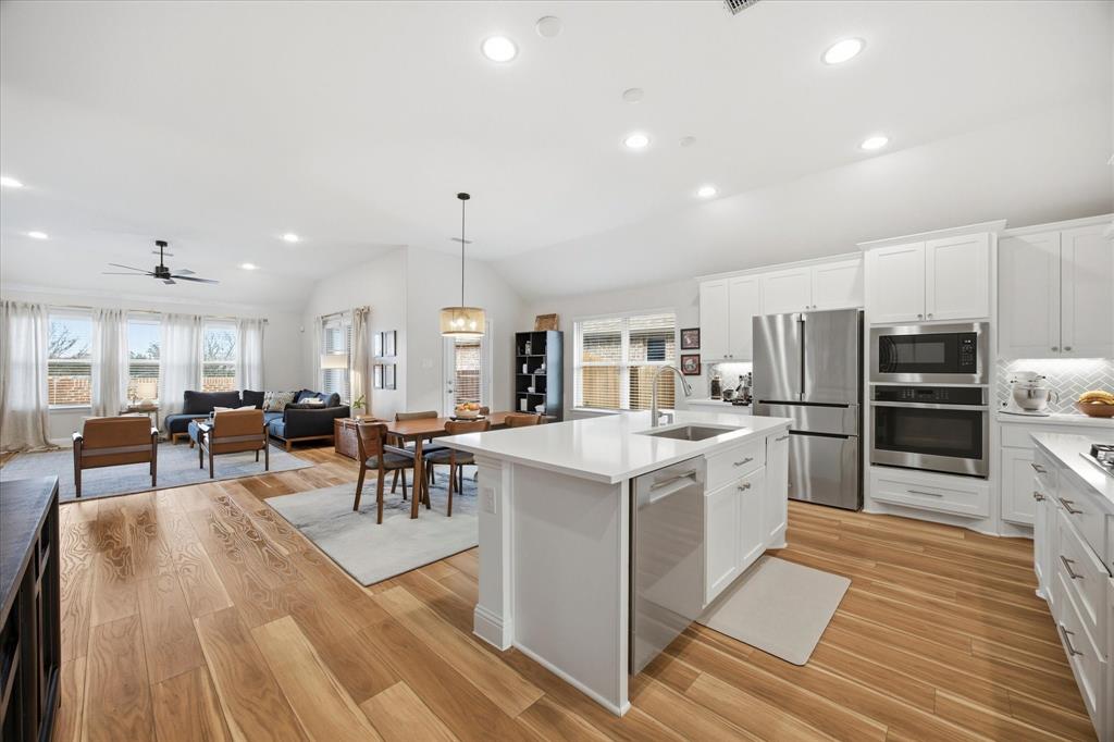 809 Mildren Lane Fate, TX 75087 - Photo 3 of 32 Beautiful open area featuring the kitchen and the living area. Great for entertaining.