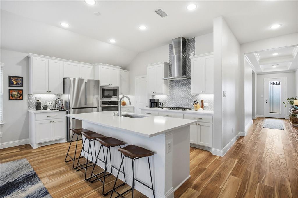 809 Mildren Lane Fate, TX 75087 - Photo 4 of 32 Nice sized island and bar stools fit comfortably under the island. Great for quick, casual meals.