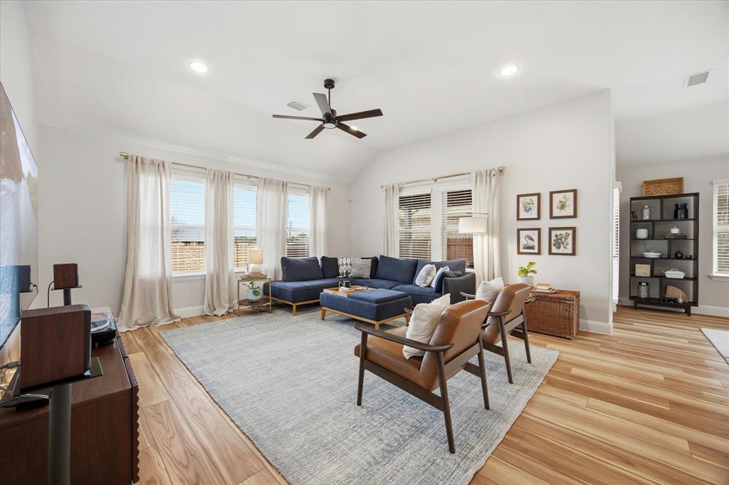 809 Mildren Lane Fate, TX 75087 - Photo 7 of 32 The living area features nice sized windows bringing in lots of light.