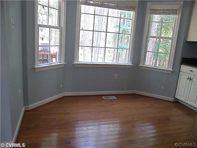21810 Sappony Road Moseley, VA 23120 - Photo 11 of 24 an empty room with wooden floor and windows