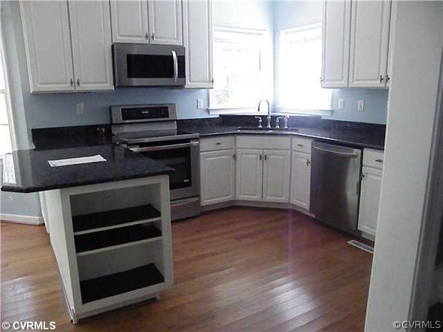 21810 Sappony Road Moseley, VA 23120 - Photo 13 of 24 a kitchen with stainless steel appliances a stove a microwave and sink