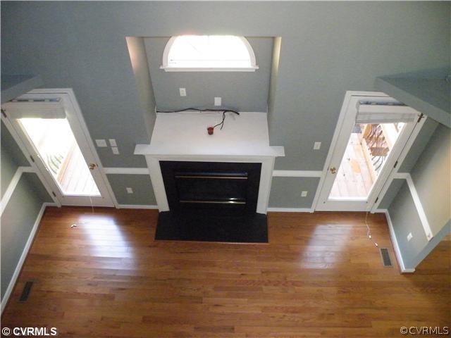 21810 Sappony Road Moseley, VA 23120 - Photo 20 of 24 a living room with a fireplace and a floor to ceiling window