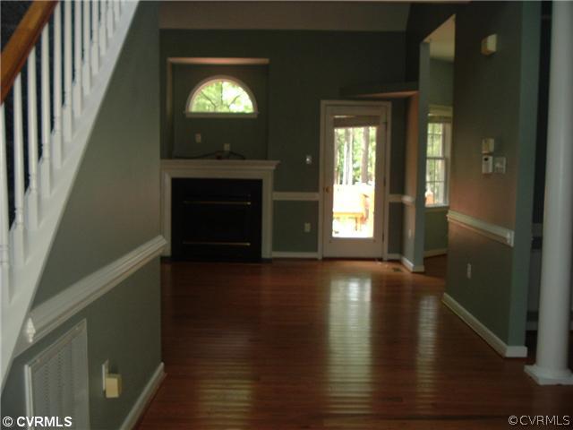 21810 Sappony Road Moseley, VA 23120 - Photo 3 of 24 a view of an empty room with wooden floor and a window