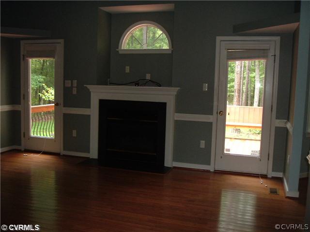 21810 Sappony Road Moseley, VA 23120 - Photo 6 of 24 a view of an empty room with wooden floor and a window