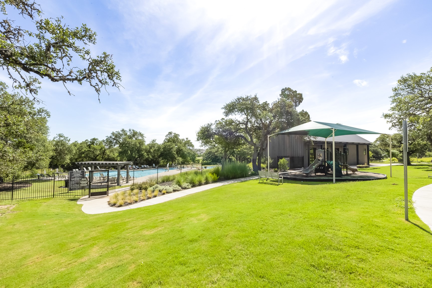 462 Old Stone Road Austin, TX 78737 - Photo 32 of 39 a view of a swimming pool and lounge chairs in the patio