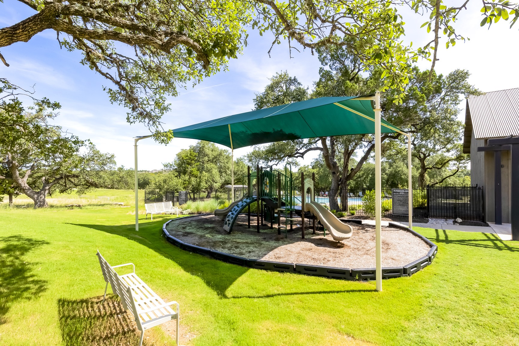 462 Old Stone Road Austin, TX 78737 - Photo 35 of 39 a view of a swimming pool with a table and chairs under an umbrella