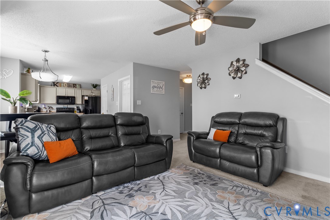 3363 Darbytown Road Henrico, VA 23231 - Photo 13 of 33 a living room with furniture a ceiling fan and a rug