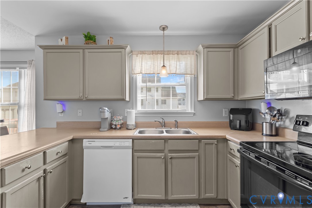 3363 Darbytown Road Henrico, VA 23231 - Photo 17 of 33 a kitchen with a sink stove cabinets and window