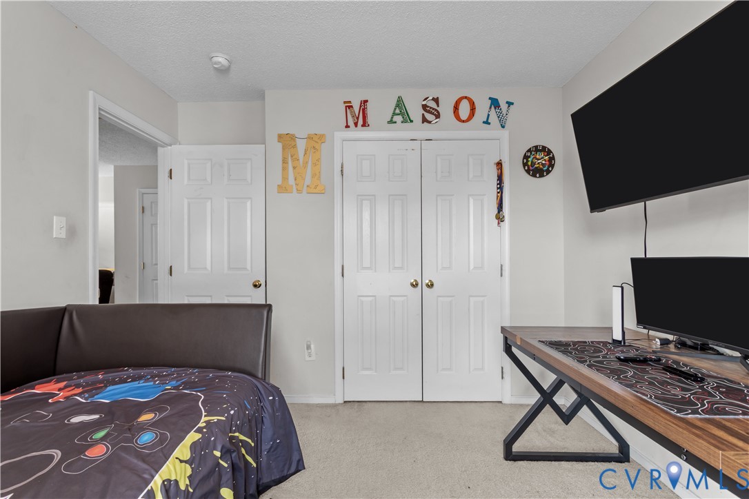 3363 Darbytown Road Henrico, VA 23231 - Photo 27 of 33 a bedroom with a bed and a flat screen tv