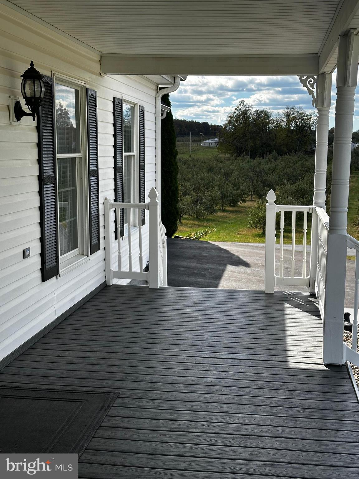 25 Mish Road Bunker Hill, WV 25413 - Photo 13 of 87 a view of a balcony with floor to ceiling windows and wooden floor