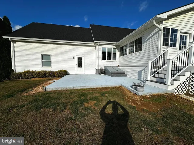 a living room with furniture a flat screen tv and a window