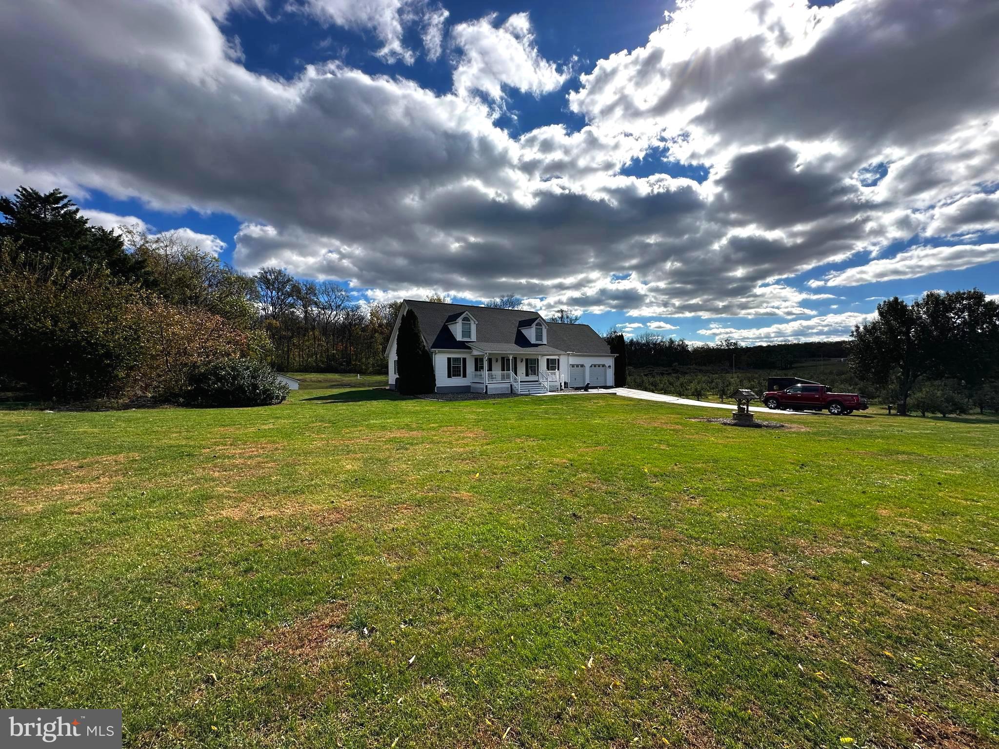 25 Mish Road Bunker Hill, WV 25413 - Photo 2 of 87 a view of a green field with house in the background
