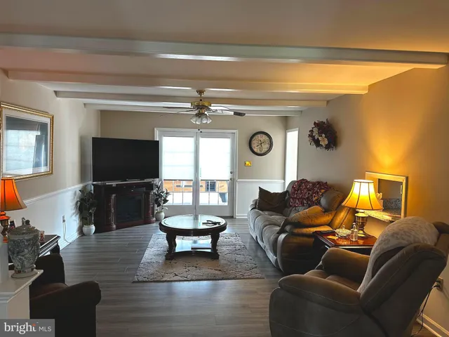 a living room with furniture a fireplace and a potted plant