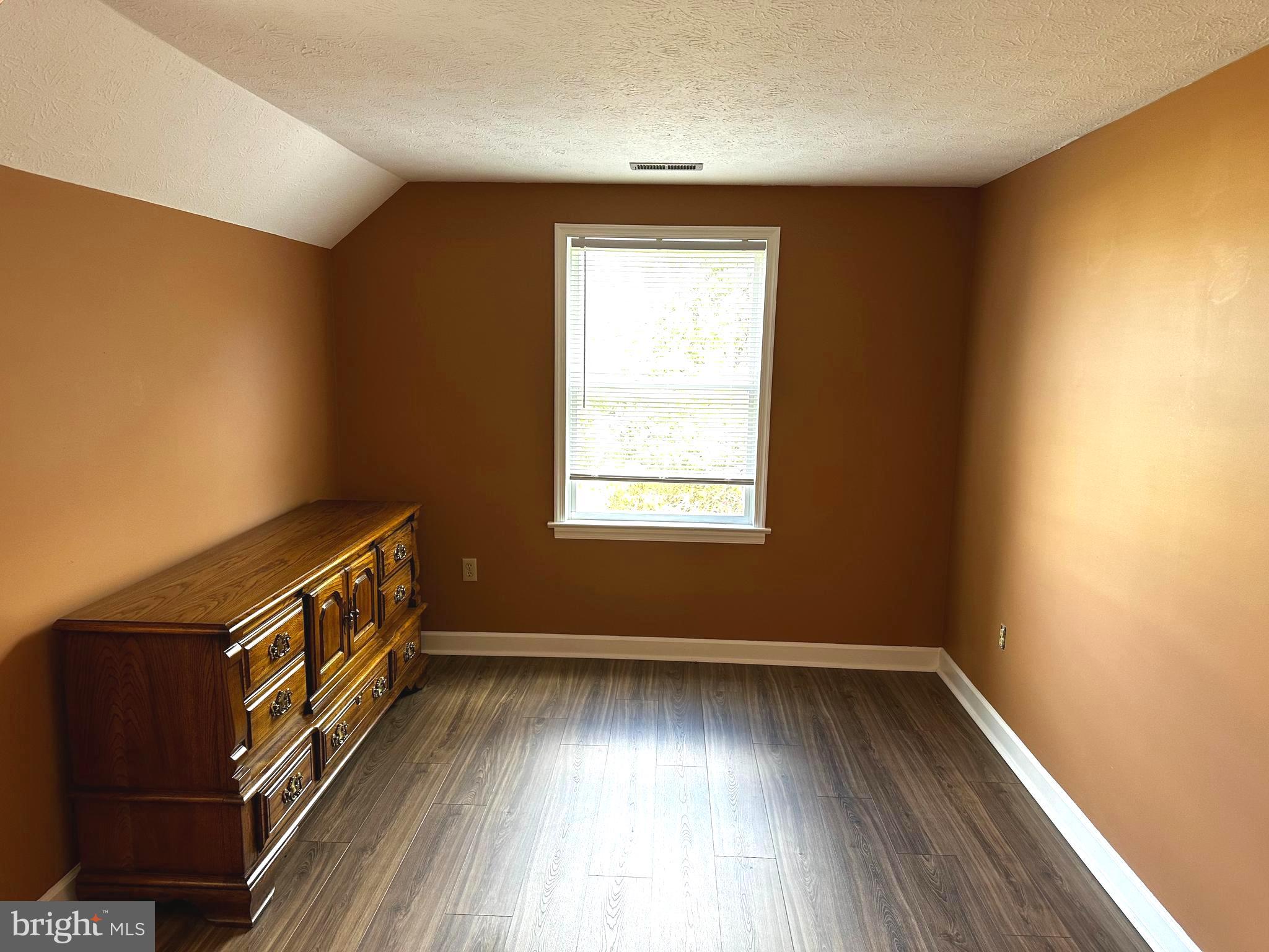 25 Mish Road Bunker Hill, WV 25413 - Photo 68 of 87 a view of an empty room with wooden floor and a window