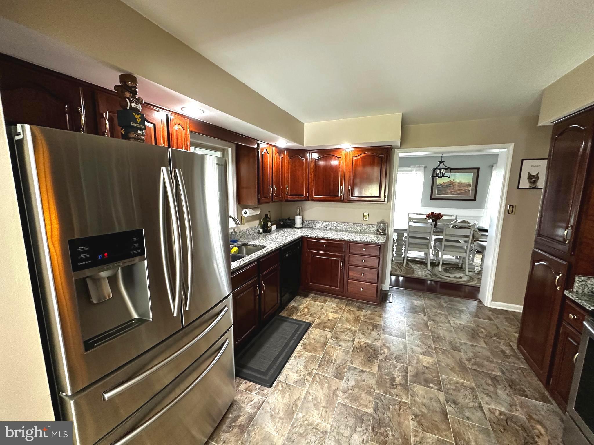 25 Mish Road Bunker Hill, WV 25413 - Photo 71 of 124 a kitchen with stainless steel appliances granite countertop a refrigerator stove and sink