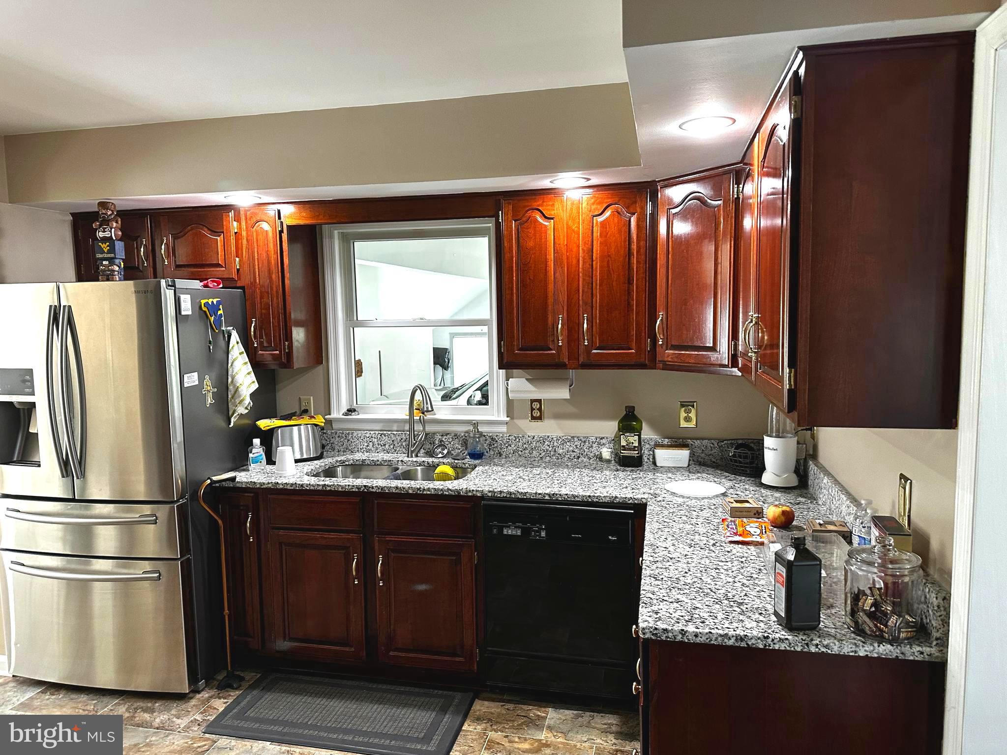 25 Mish Road Bunker Hill, WV 25413 - Photo 77 of 124 a kitchen with a sink a refrigerator and a stove