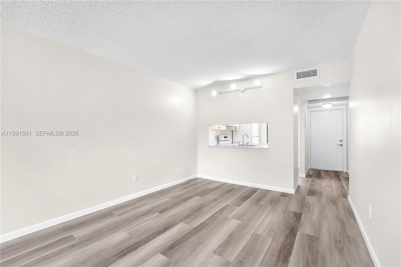 7668 Southwest 152nd Avenue, Unit 2107 Miami, FL 33193 - Photo 11 of 17 a view of a hallway with wooden floor