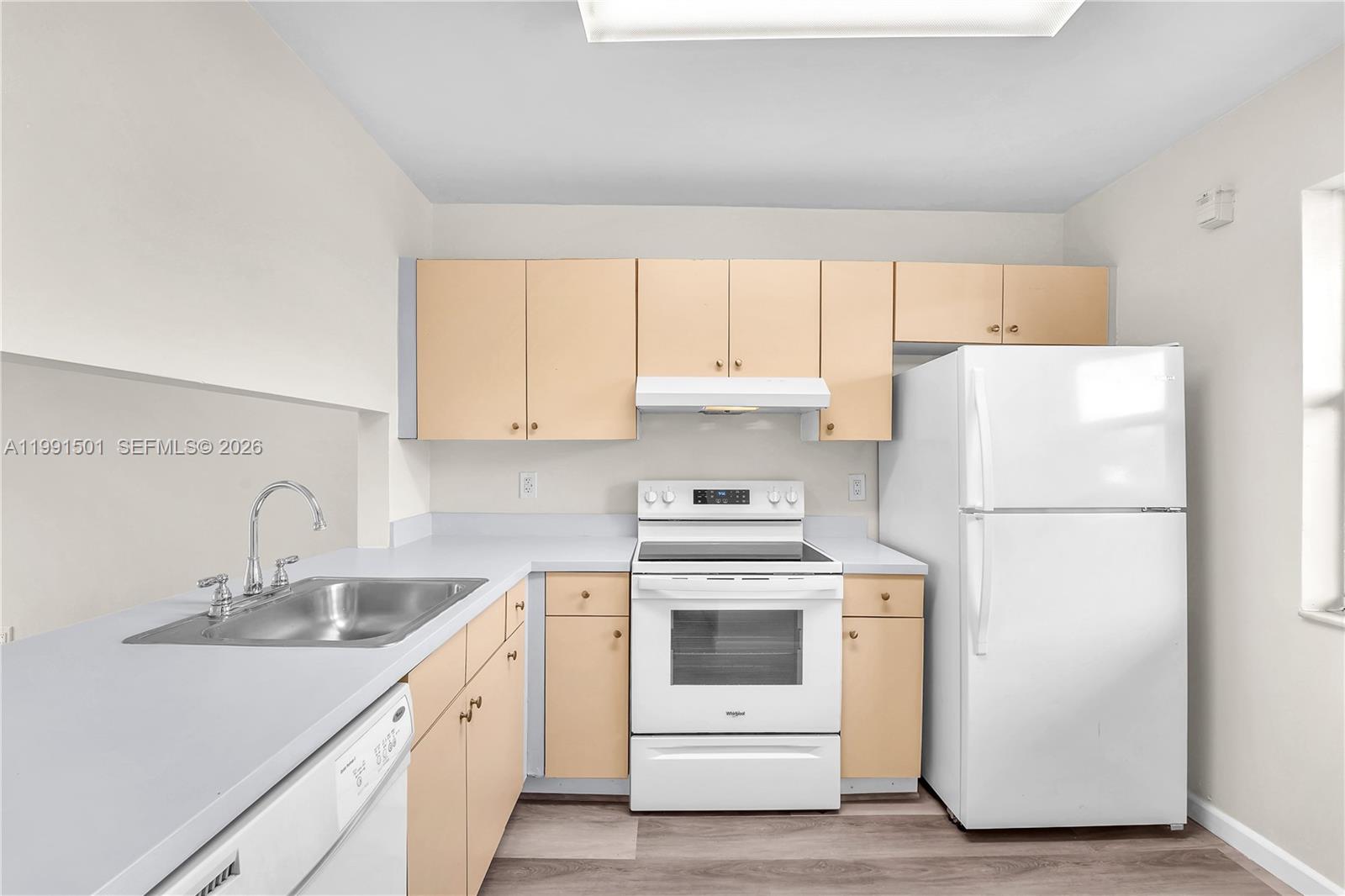 7668 Southwest 152nd Avenue, Unit 2107 Miami, FL 33193 - Photo 12 of 17 a kitchen with a white cabinets and white appliances