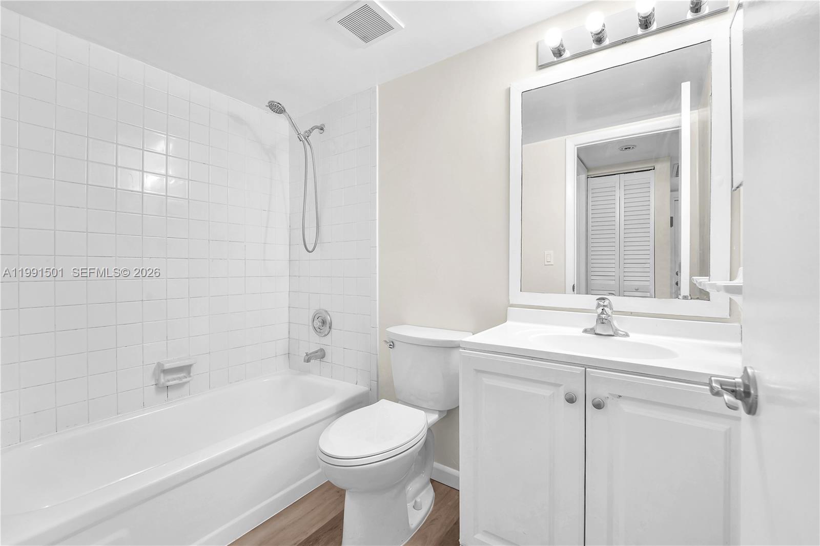 7668 Southwest 152nd Avenue, Unit 2107 Miami, FL 33193 - Photo 17 of 17 a bathroom with a sink a toilet and shower