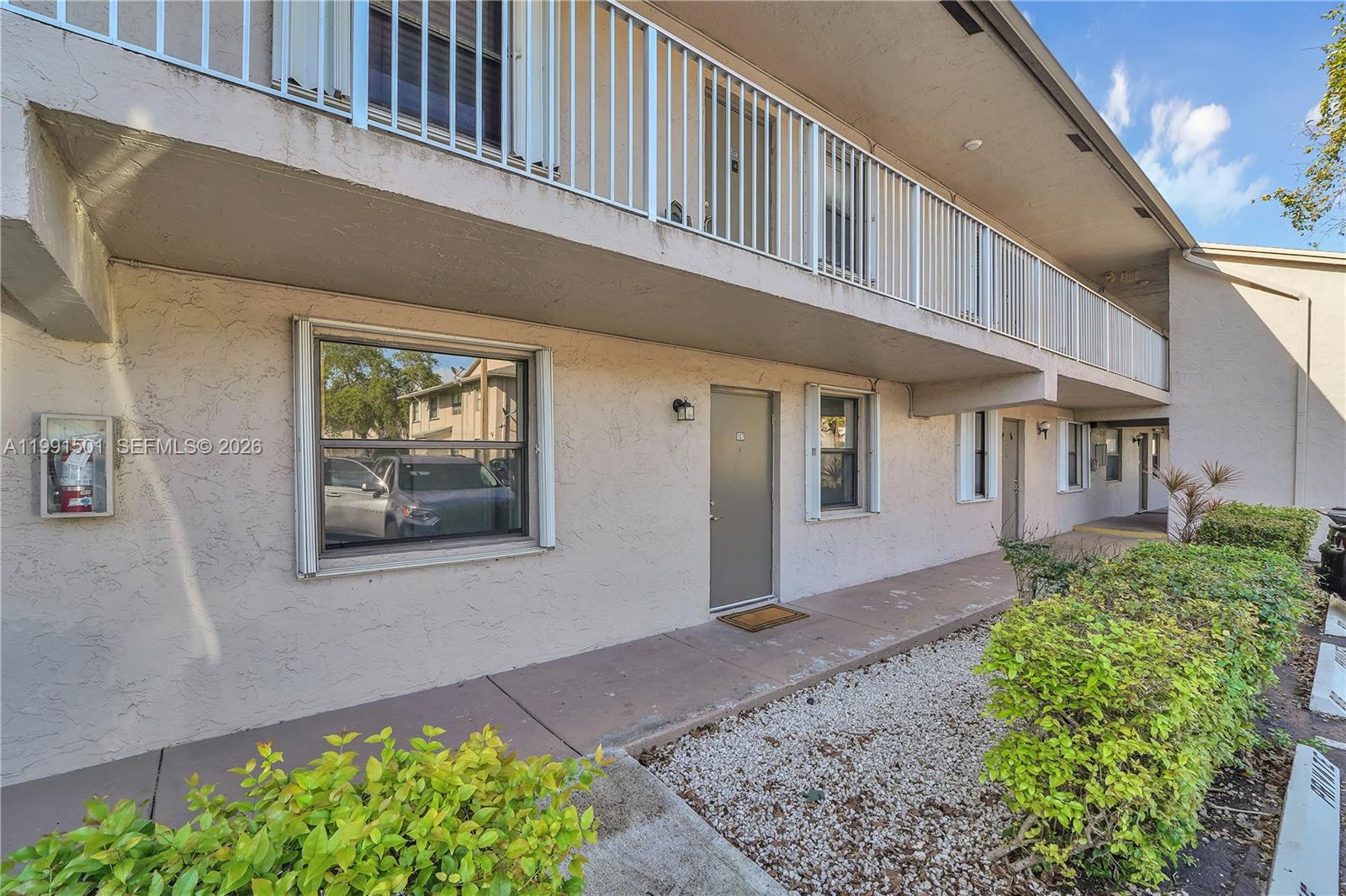 7668 Southwest 152nd Avenue, Unit 2107 Miami, FL 33193 - Photo 2 of 17 a front view of a house with garden