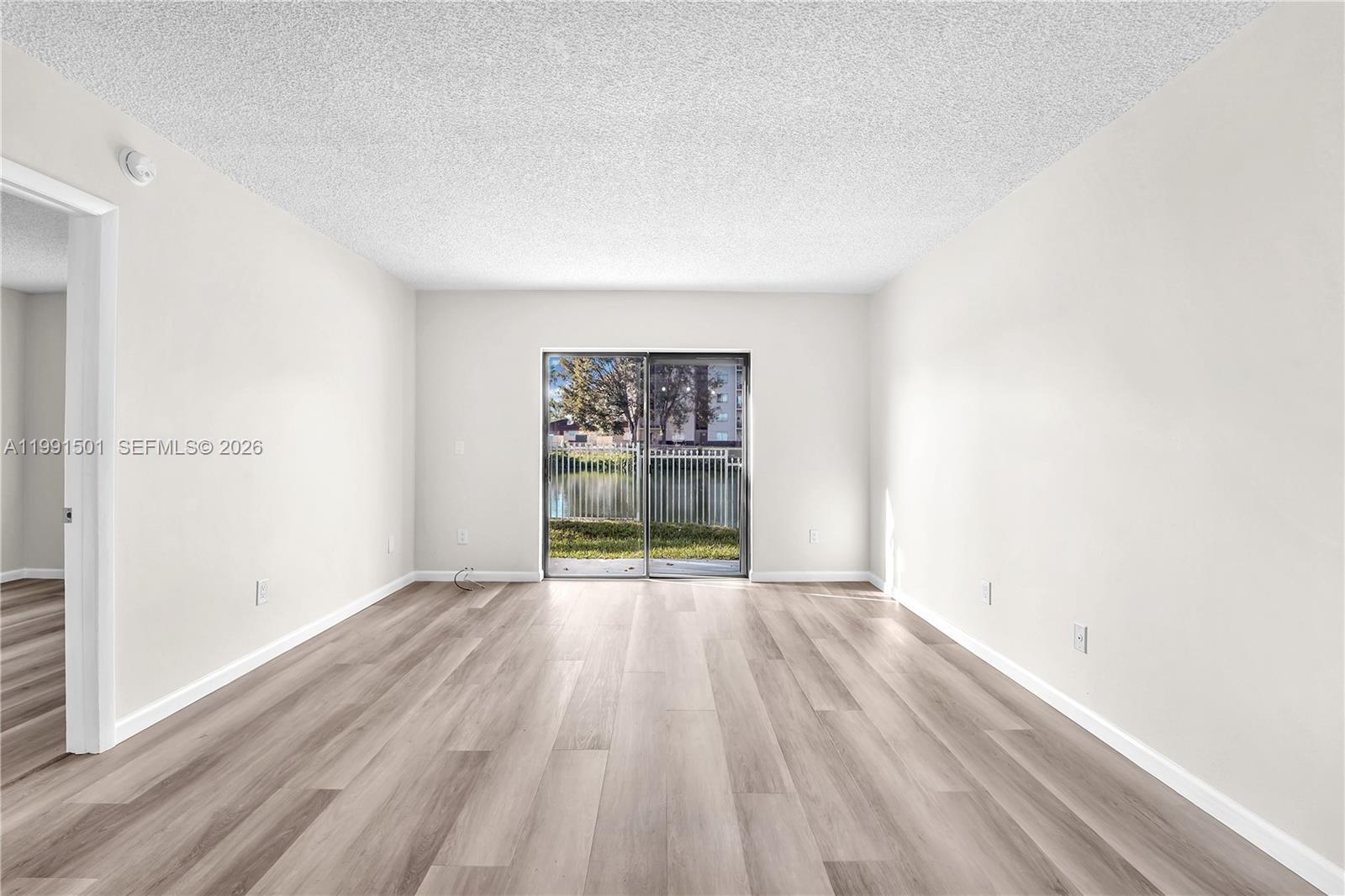 7668 Southwest 152nd Avenue, Unit 2107 Miami, FL 33193 - Photo 6 of 17 a view of an empty room and a window