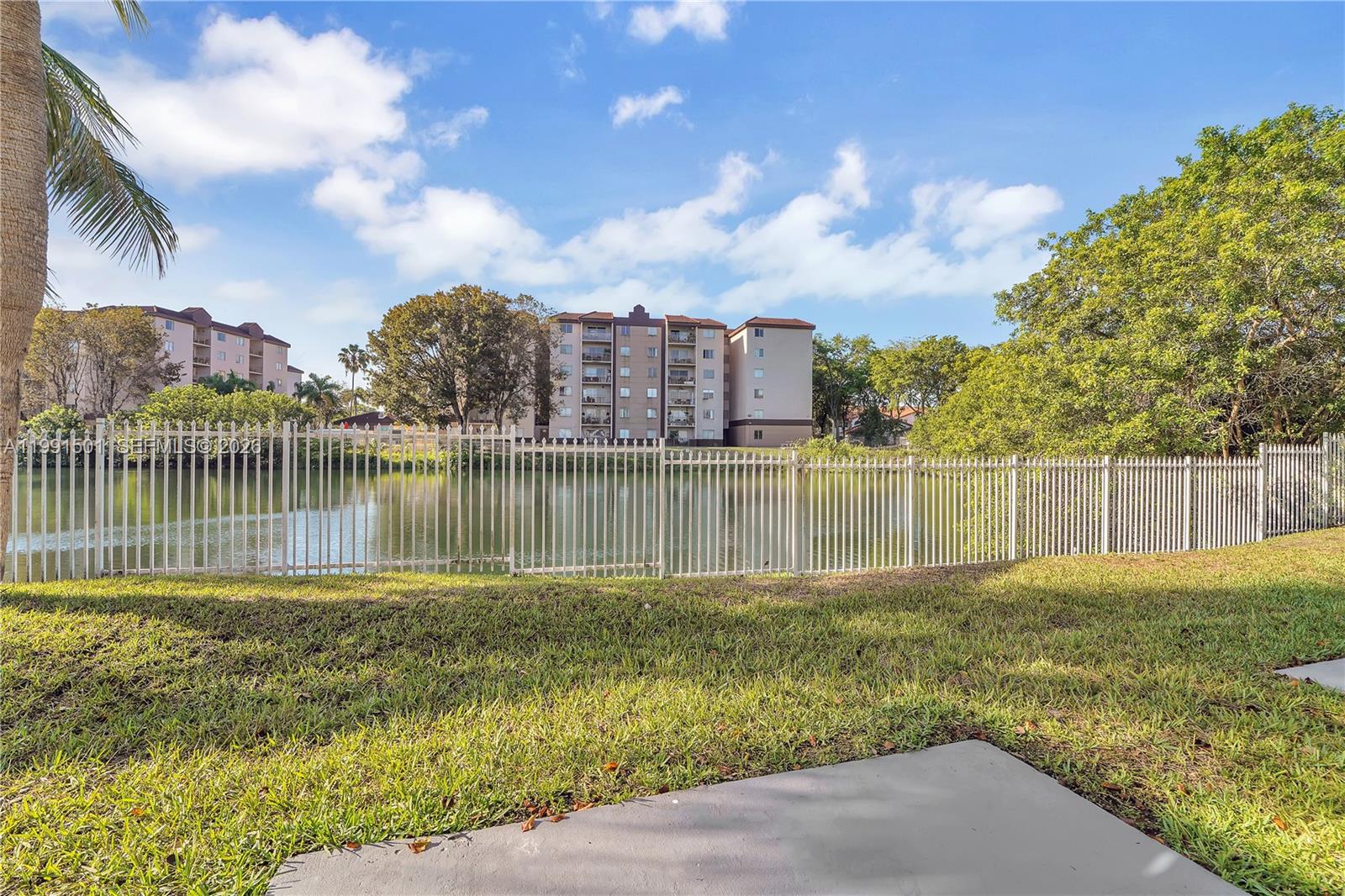 7668 Southwest 152nd Avenue, Unit 2107 Miami, FL 33193 - Photo 7 of 17 a backyard of a house with a lake view