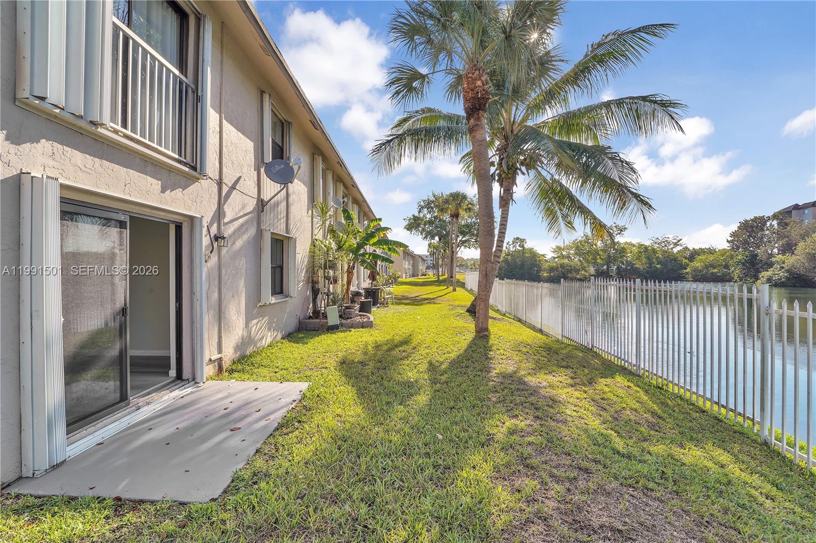 7668 Southwest 152nd Avenue, Unit 2107 Miami, FL 33193 - Photo 8 of 17 a view of a house with swimming pool next to a lake view
