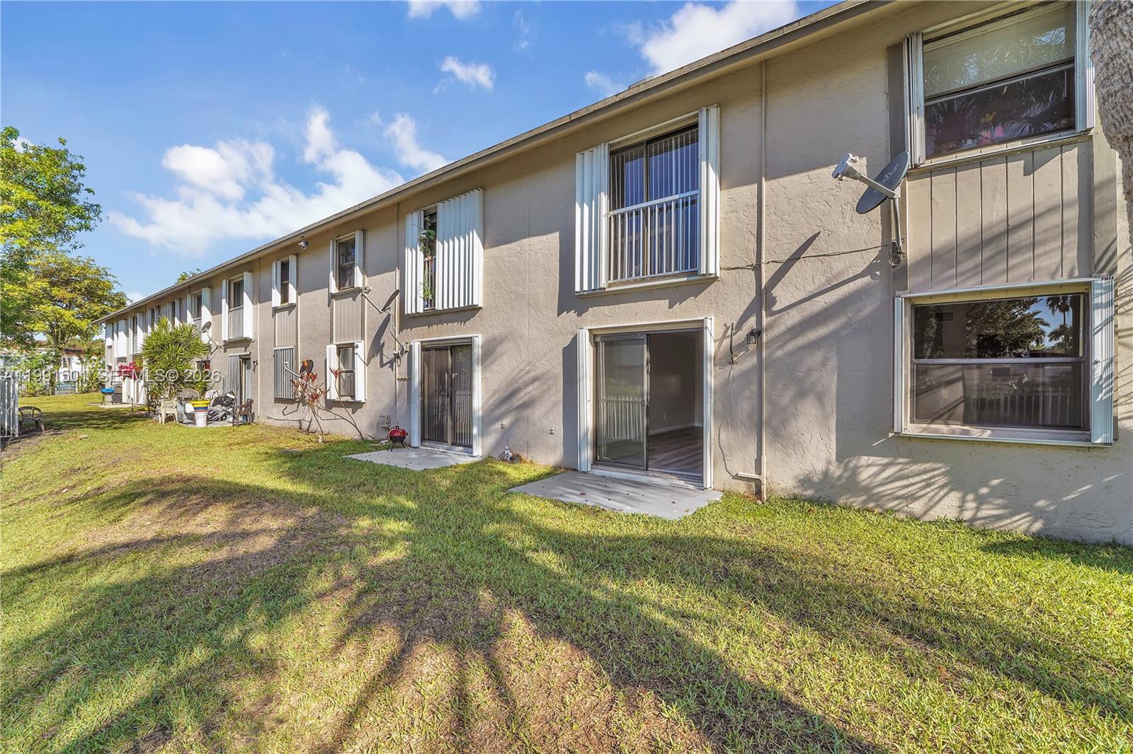 7668 Southwest 152nd Avenue, Unit 2107 Miami, FL 33193 - Photo 9 of 17 a view of a house with a yard