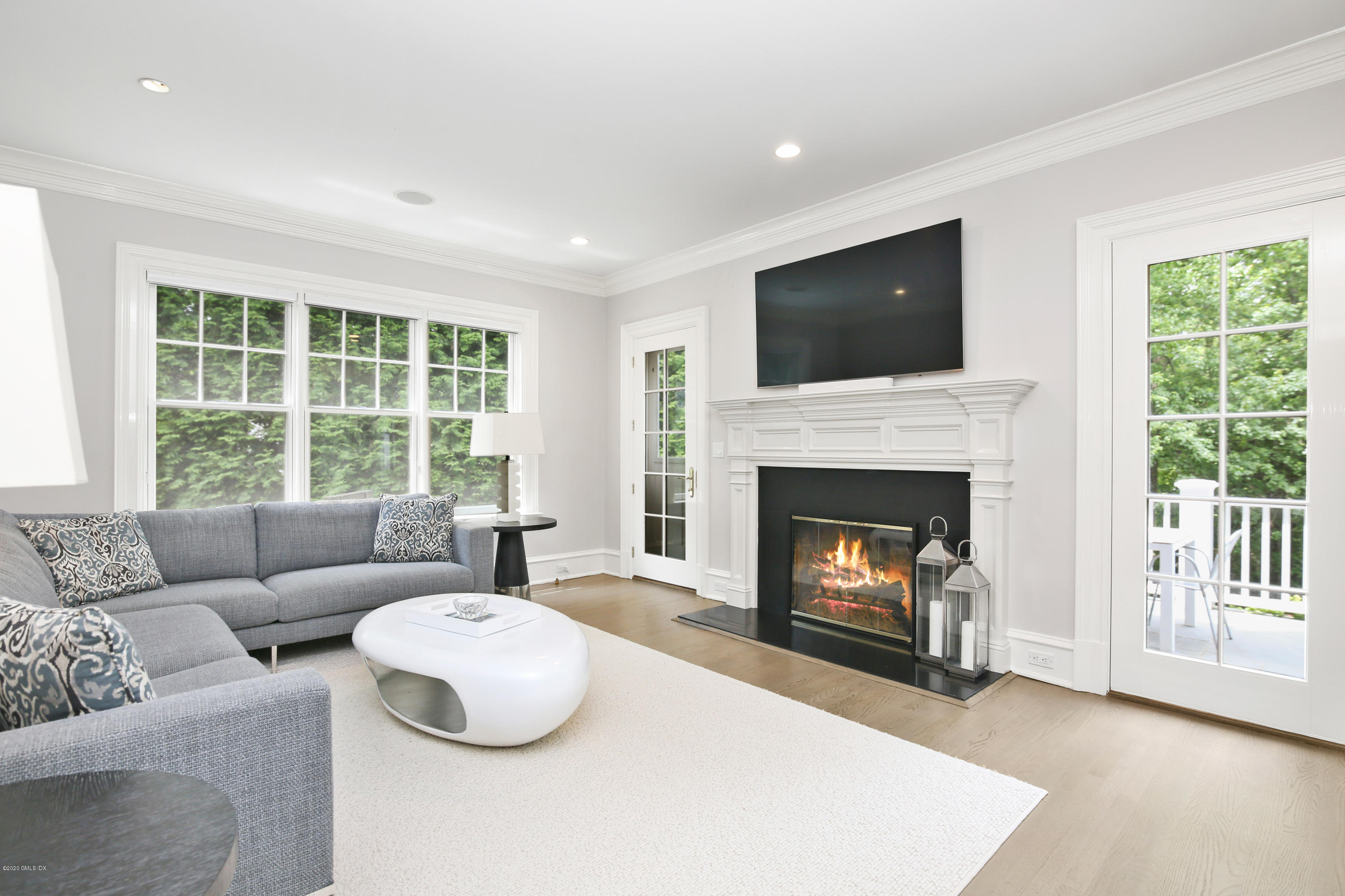 67 Lockwood Road Riverside, CT 06878 - Photo 12 of 30 a living room with furniture a flat screen tv and a fireplace