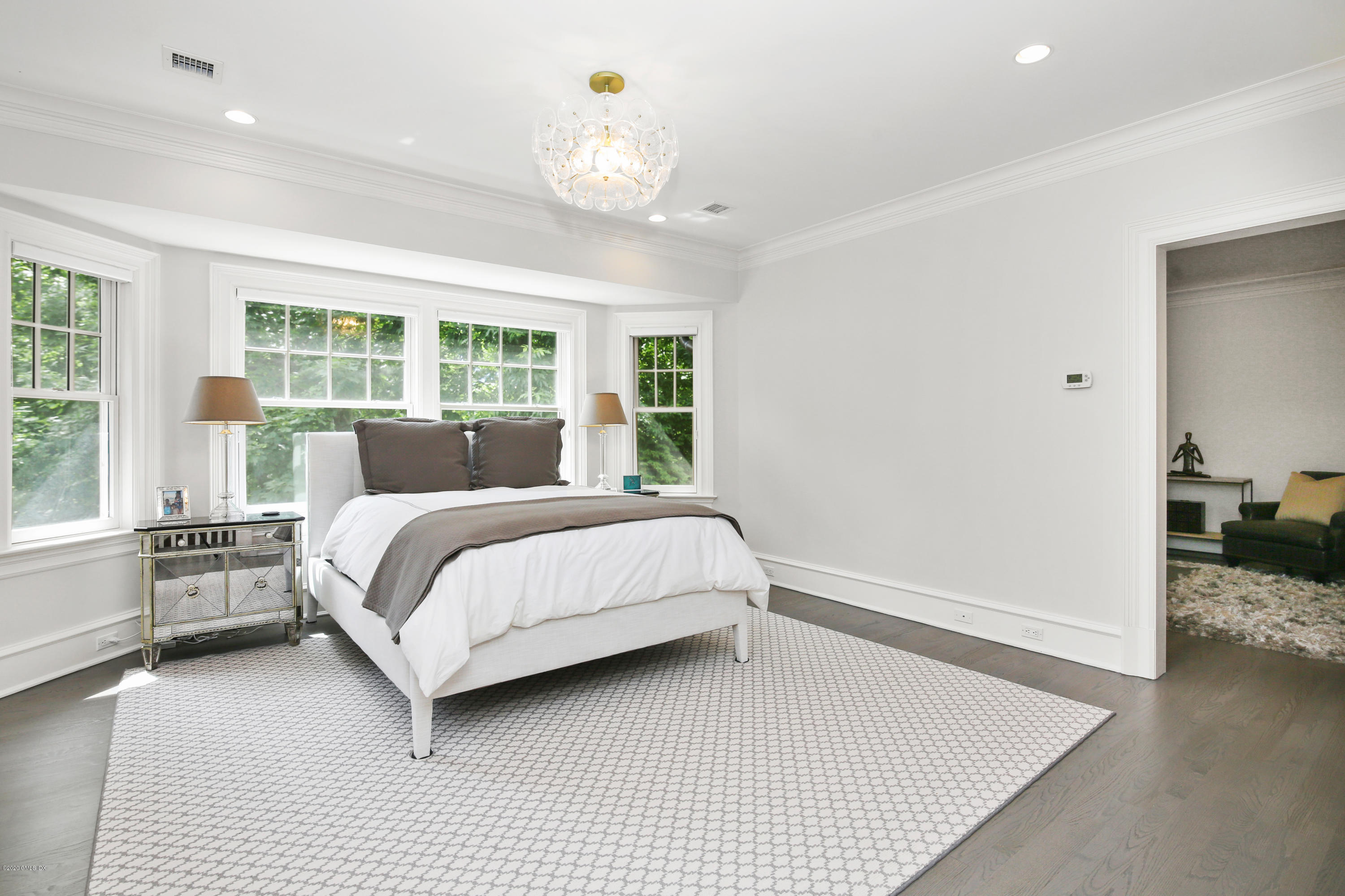 67 Lockwood Road Riverside, CT 06878 - Photo 14 of 30 a bedroom with a large bed and a chandelier