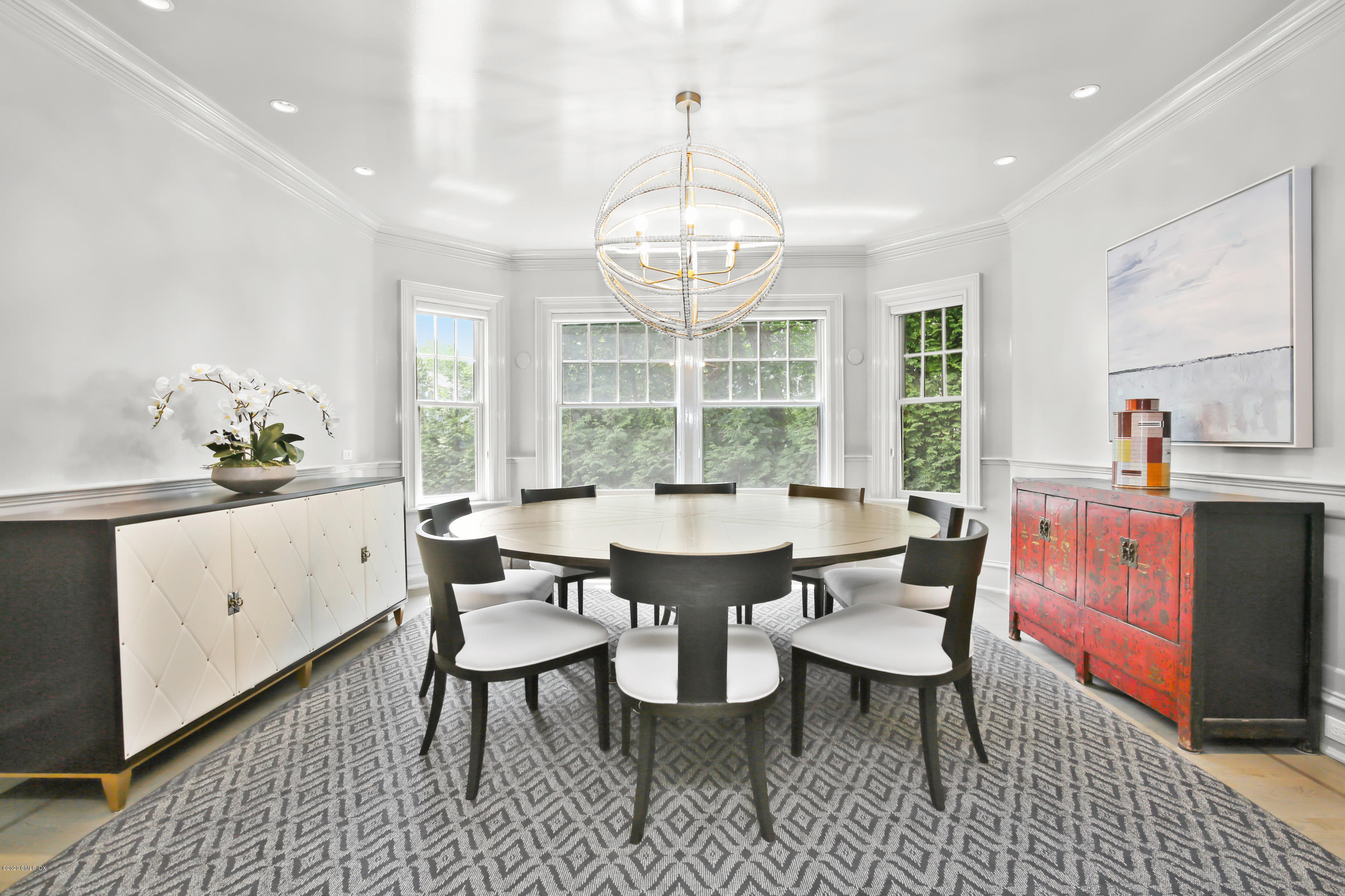 67 Lockwood Road Riverside, CT 06878 - Photo 7 of 30 a dining room with wooden floor a chandelier a glass table and chairs