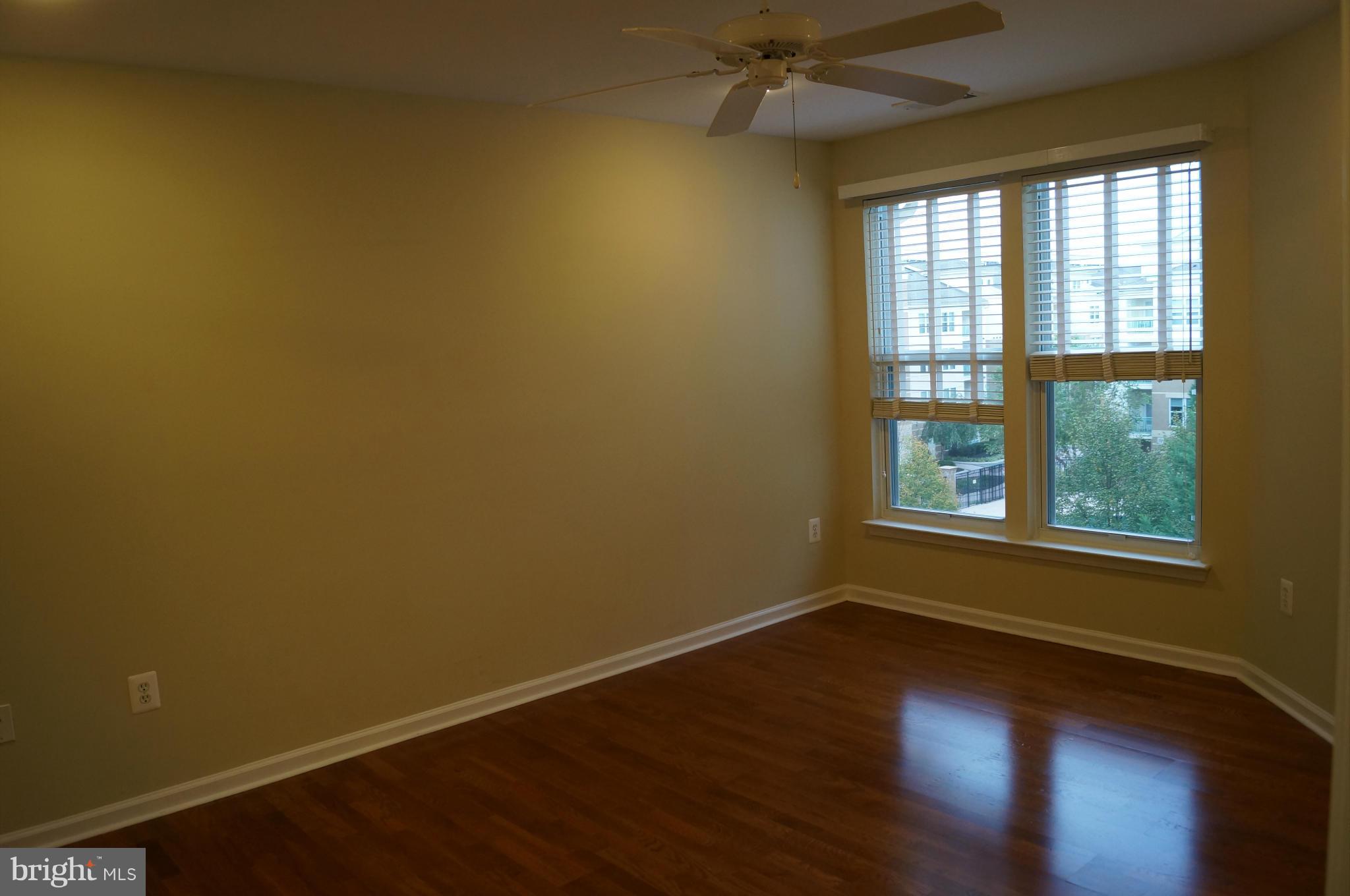 12000 Market Street, Unit 425 Reston, VA 20190 - Photo 15 of 30 an empty room with wooden floor and windows