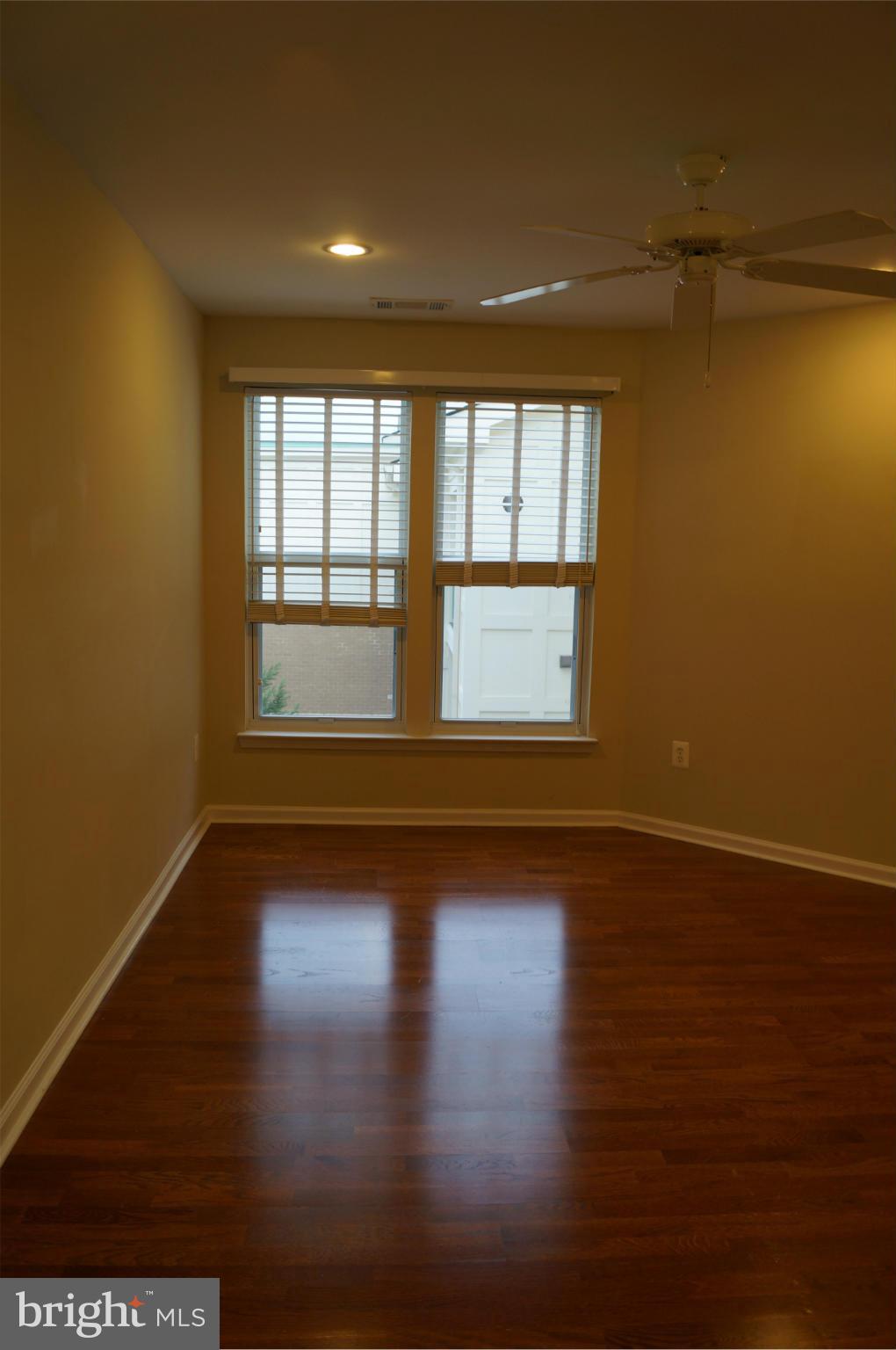 12000 Market Street, Unit 425 Reston, VA 20190 - Photo 17 of 30 a view of empty room with wooden floor and fan