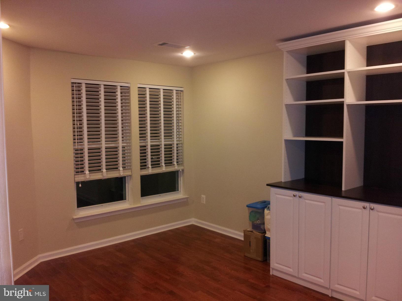 12000 Market Street, Unit 425 Reston, VA 20190 - Photo 3 of 30 a view of an empty room with a window and wooden floor