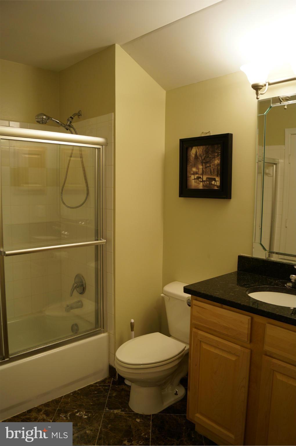 12000 Market Street, Unit 425 Reston, VA 20190 - Photo 10 of 30 a bathroom with a toilet a sink and shower