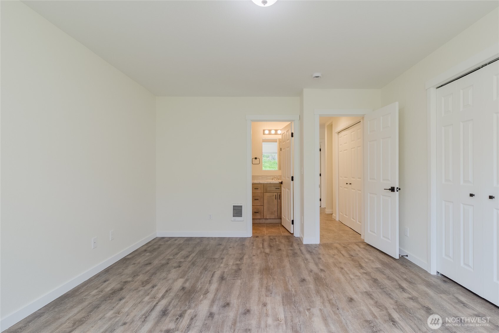 506 Edith Avenue Walla Walla, WA 99362 - Photo 7 of 18 a view of a room with wooden floor and white doors