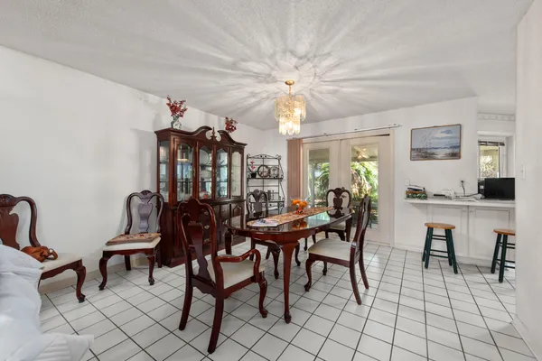 a view of a dining room with furniture and chandelier