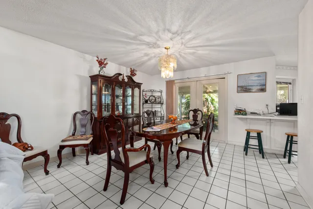 an empty room with windows and ceiling fan