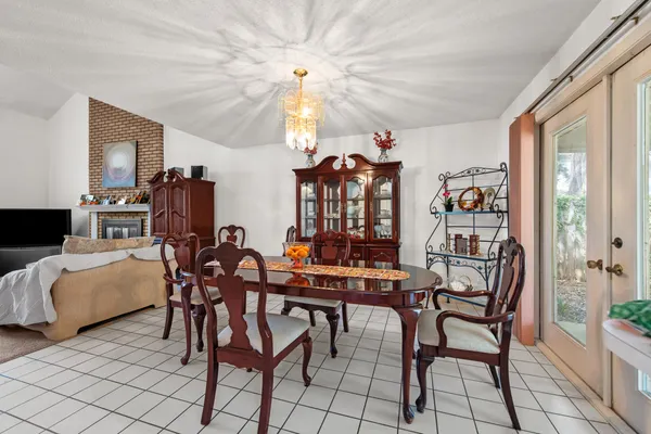 a view of a dining room with furniture and chandelier