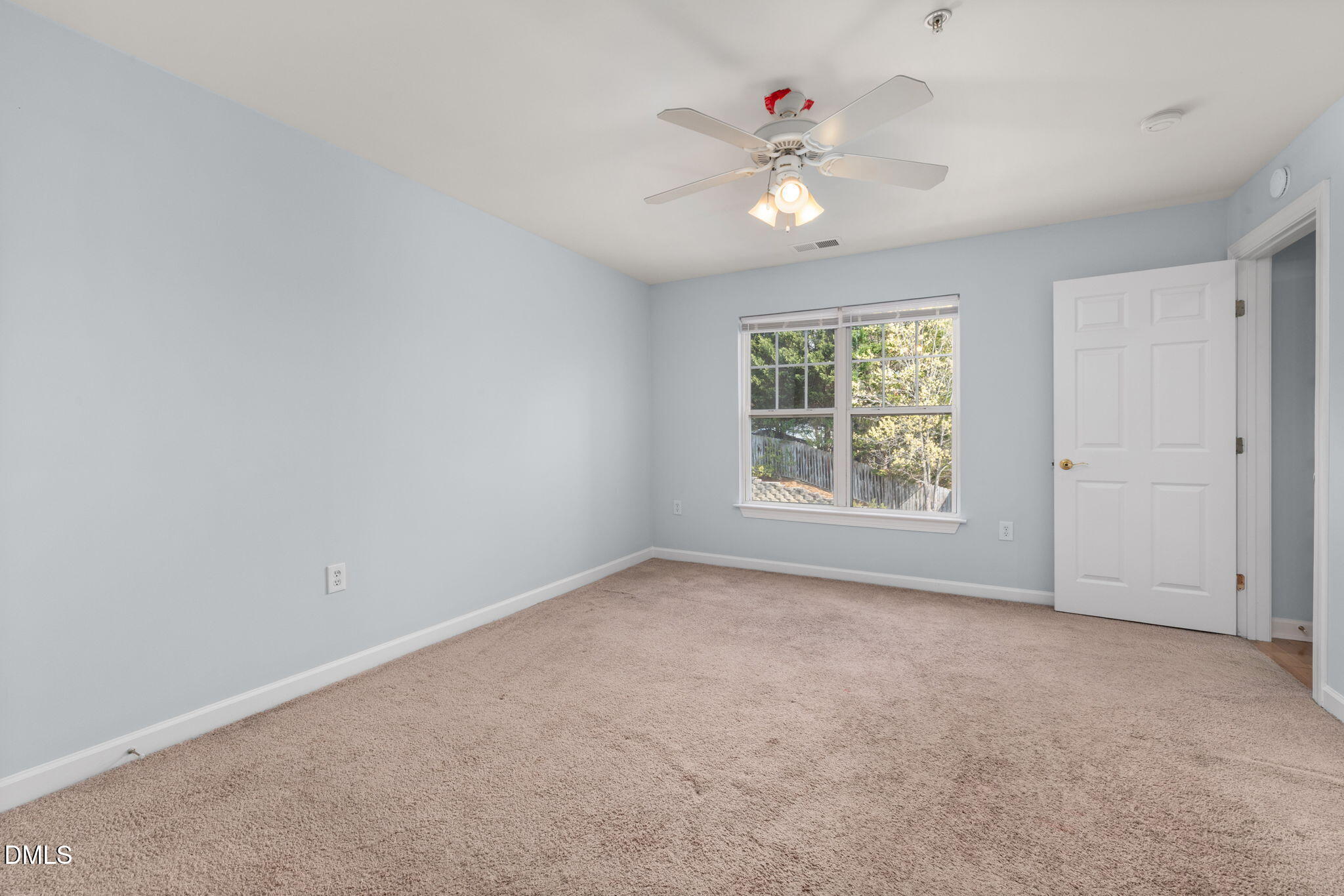 929 Morreene Road, Unit C23 Durham, NC 27705 - Photo 19 of 33 an empty room with windows and chandelier fan