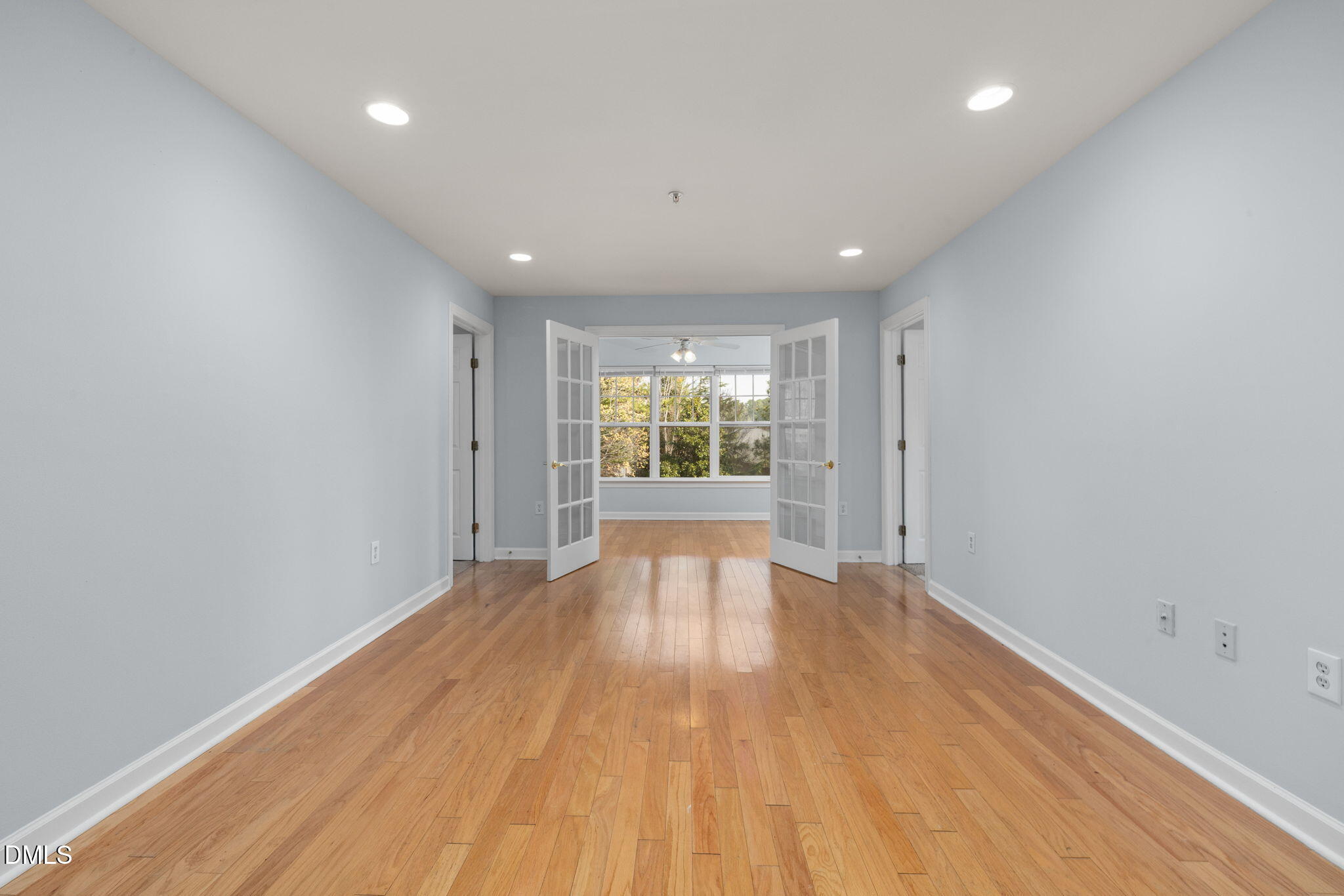 929 Morreene Road, Unit C23 Durham, NC 27705 - Photo 6 of 33 a view of an empty room with wooden floor and a window