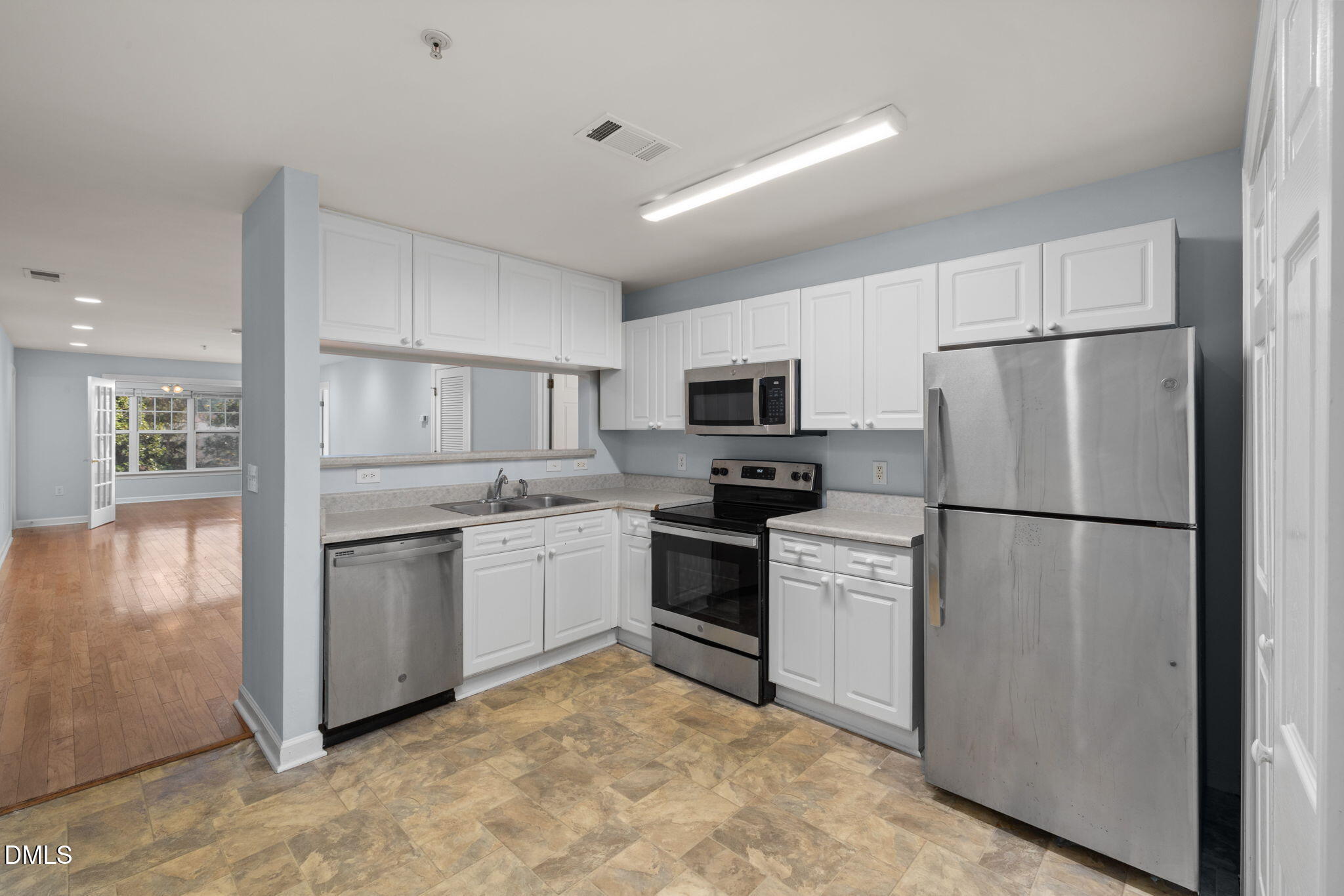 929 Morreene Road, Unit C23 Durham, NC 27705 - Photo 8 of 33 a kitchen with white cabinets and white appliances